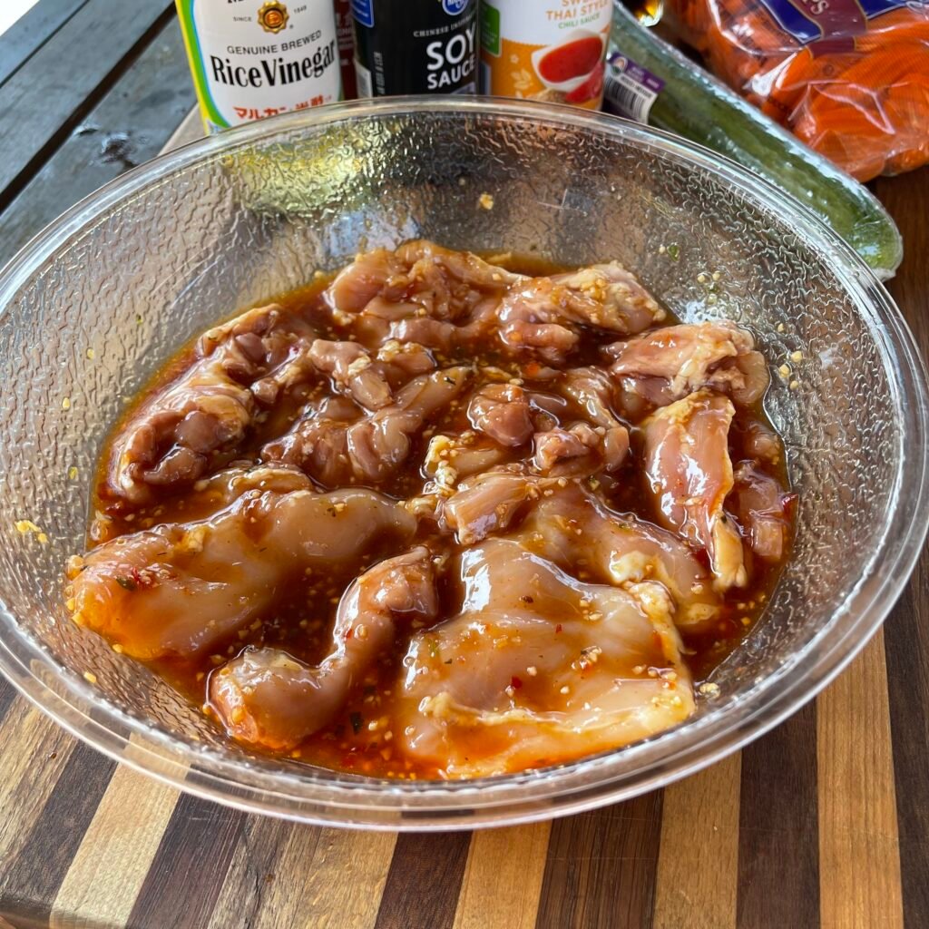 chicken thighs in marinade in a bowl. 