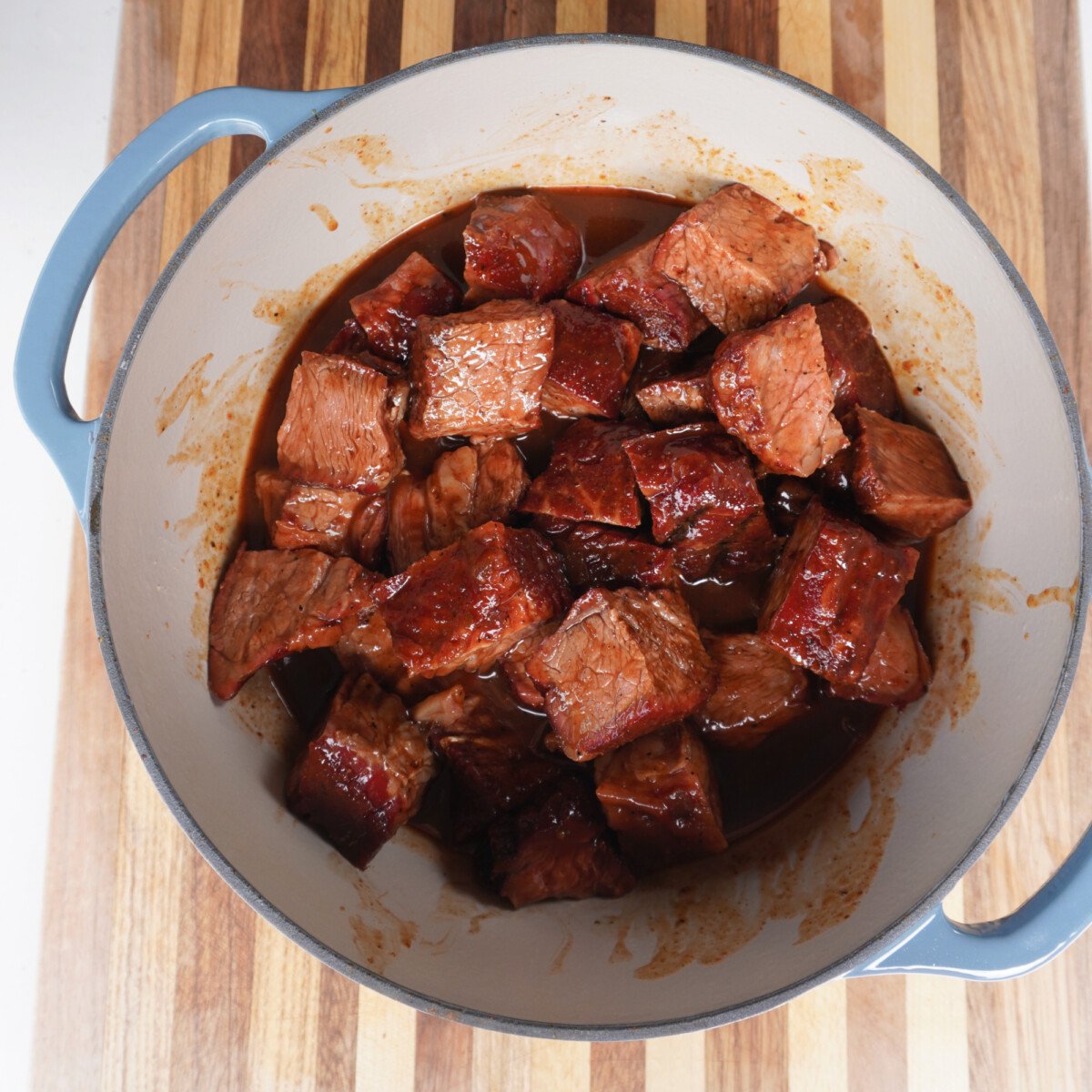 sauced burnt ends in beer bbq sauce in dutch oven.