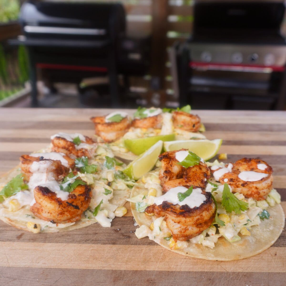 3 grilled shrimp with corn slaw tacos on cutting board. Corn slaw for the grilled shrimp tacos.