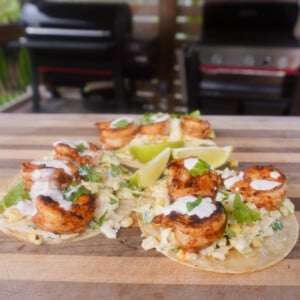 3 grilled shrimp with corn slaw tacos on cutting board
