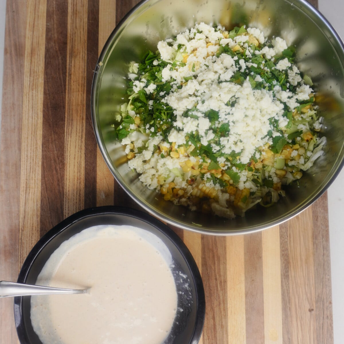 corn slaw ingredients.  Creamy sauce and cut up veggies.