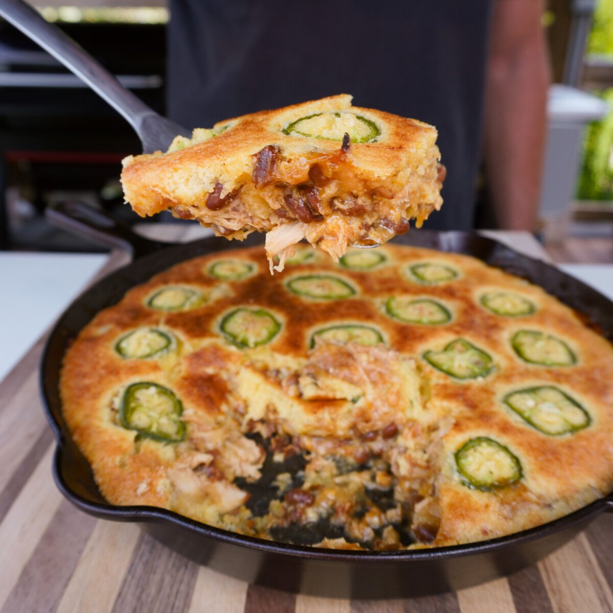 BBQ Chicken Cornbread Casserole wedge lifted from cast iron skillet.