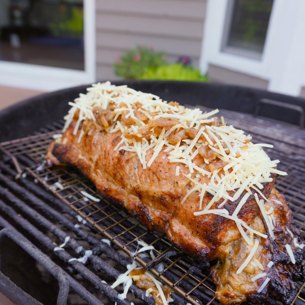 grilled french pork loin on a weber kettle grill.