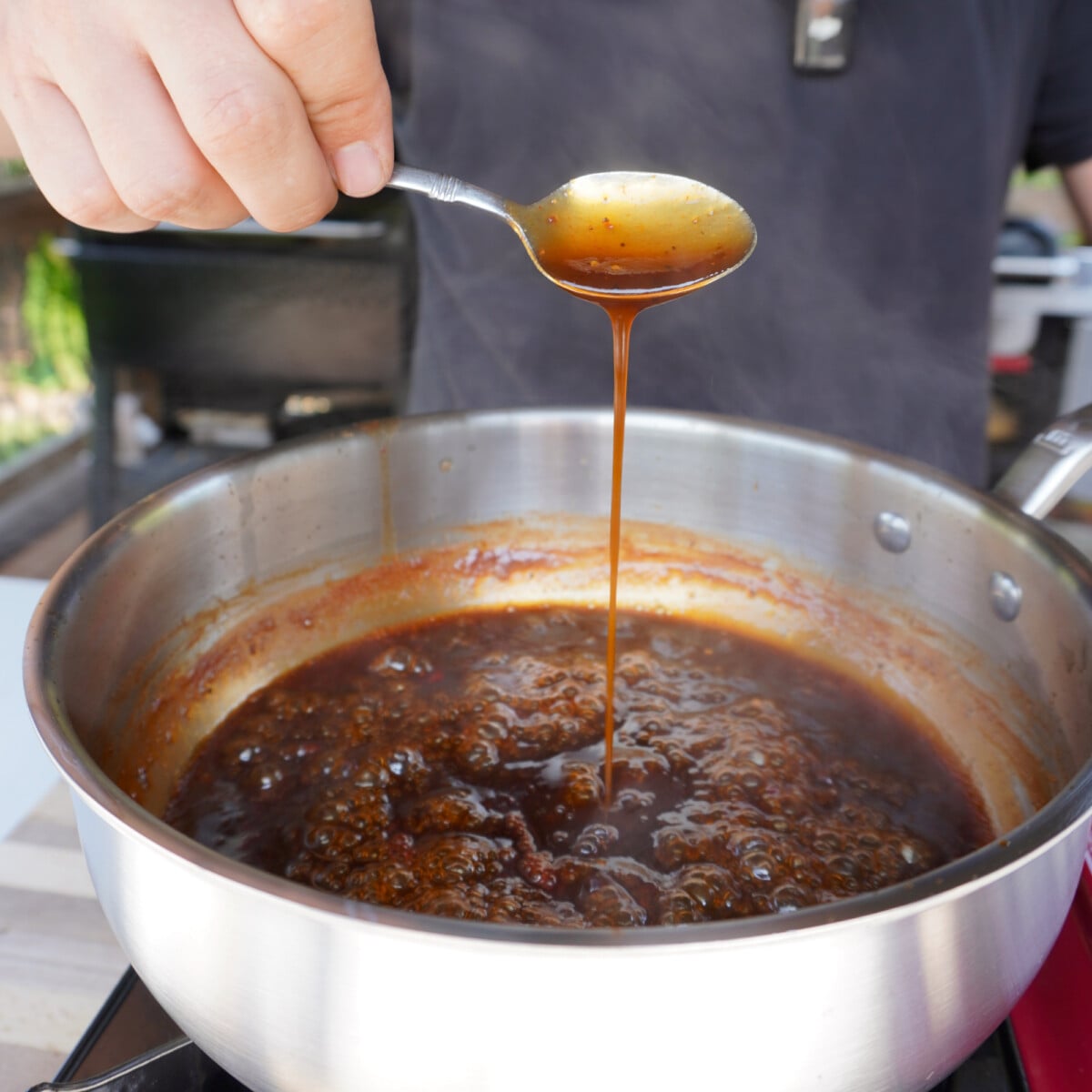 homemade jack and coke bbq sauce in saucepan.