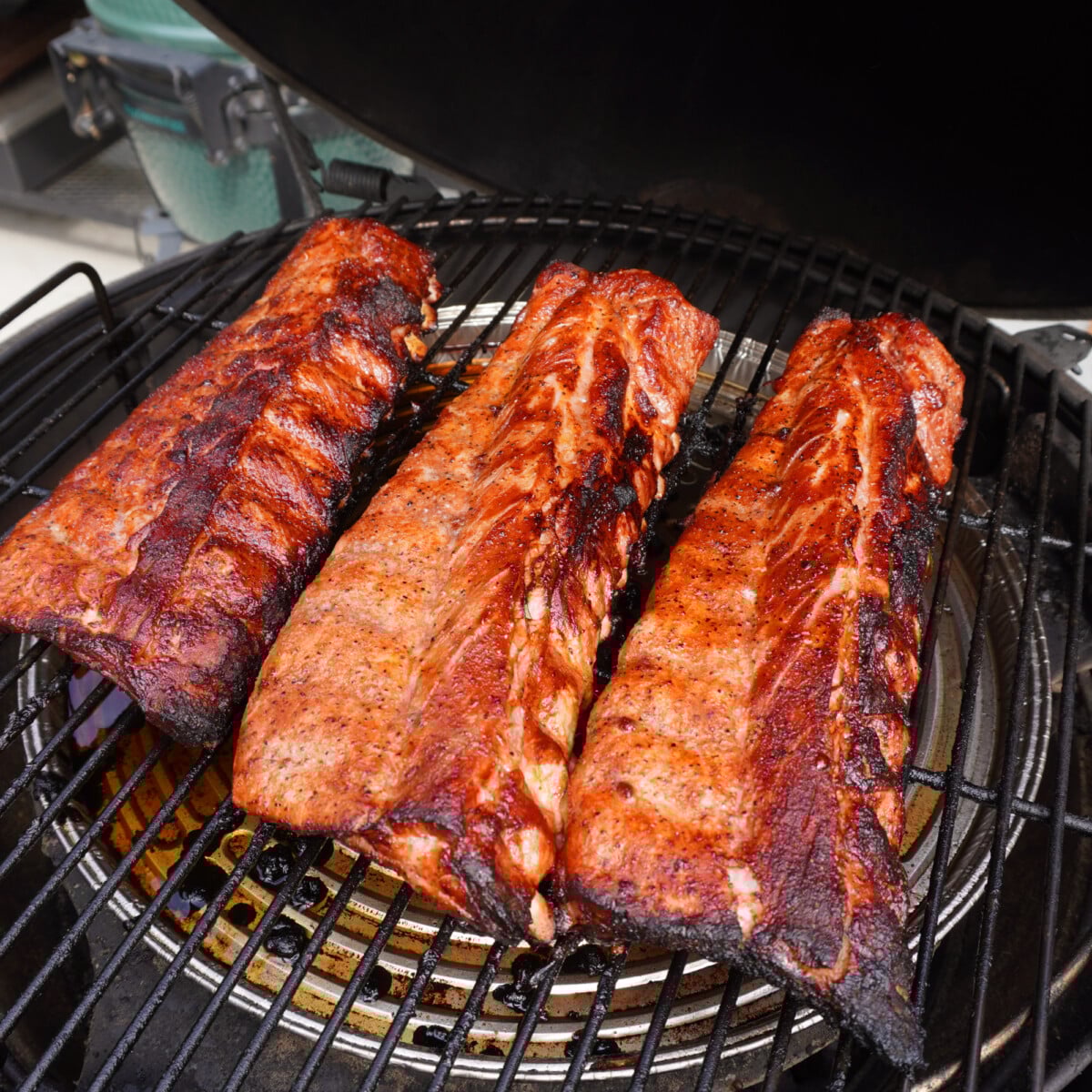 smoked baby back ribs on grill.