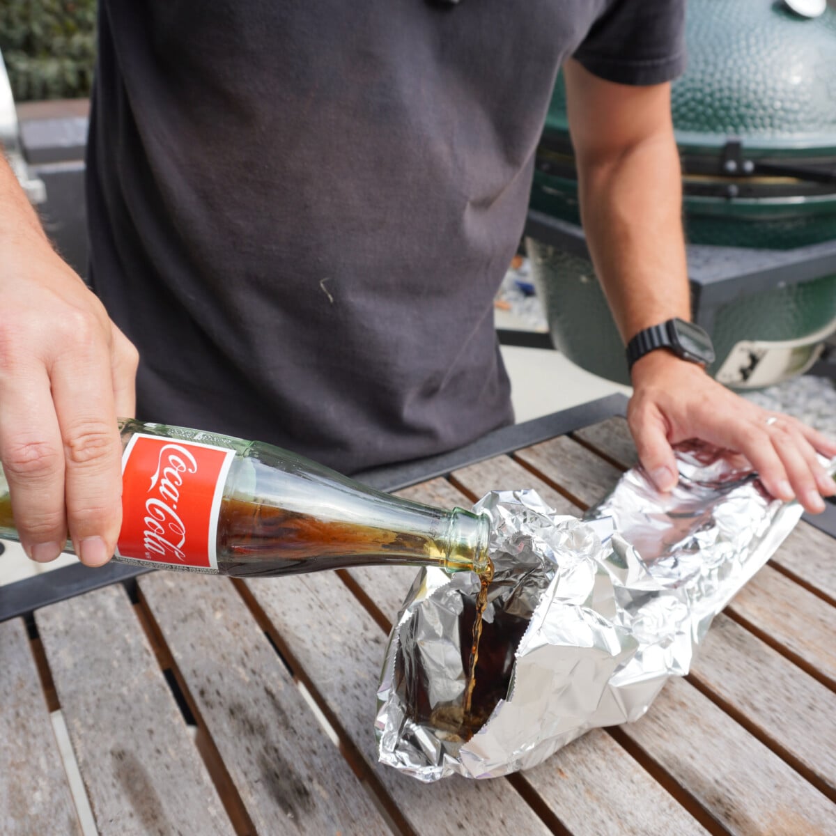 pouring coke into wrapped and smoked ribs.