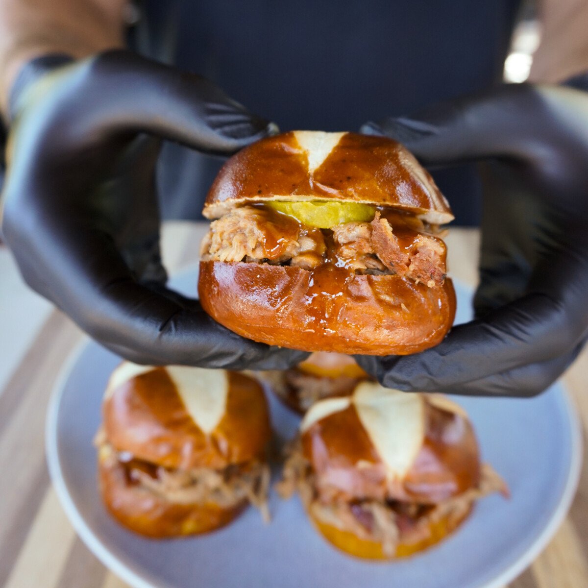 smoked pulled pork with mustard bbq sauce sandwich presented.