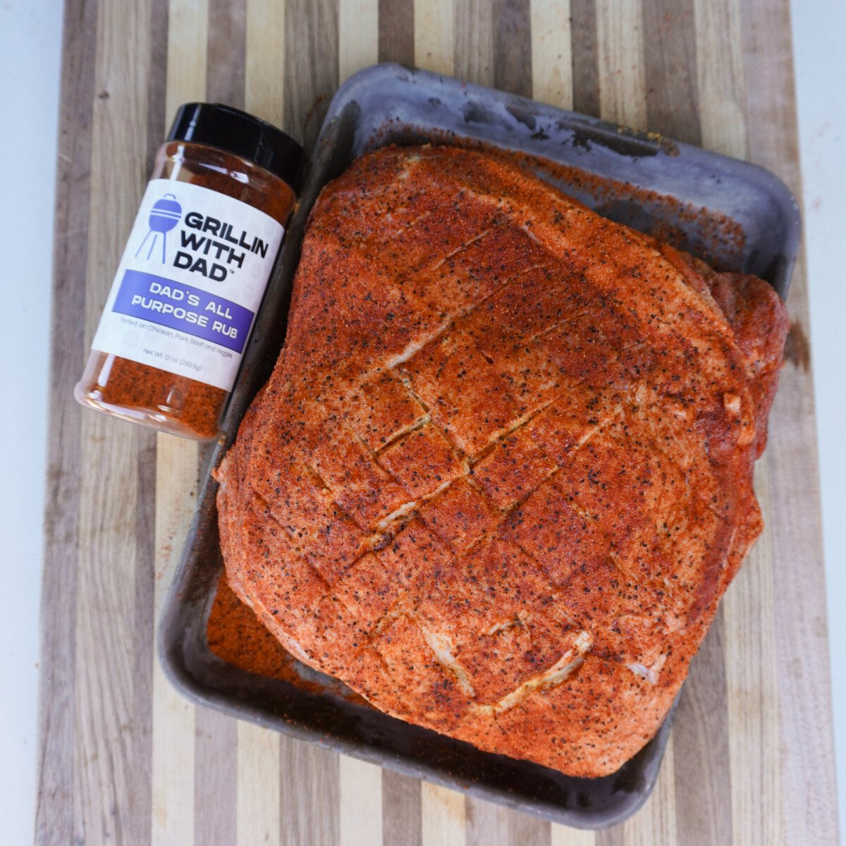 seasoned raw pork shoulder on a tray.