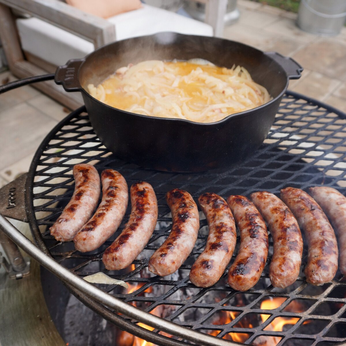 searing brats directly over the fire to build a crust.