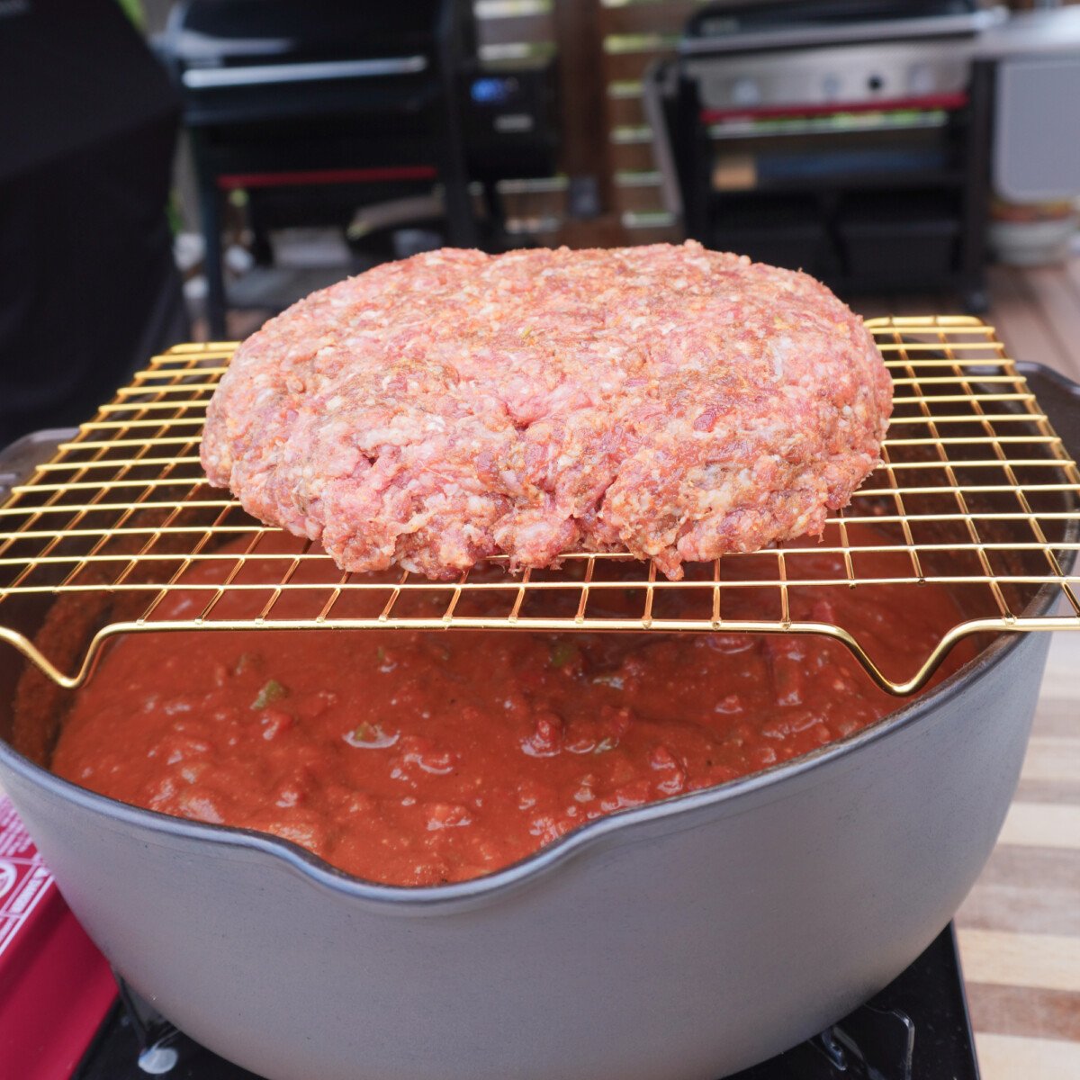 beef patty on a wire rack over the chili mix.