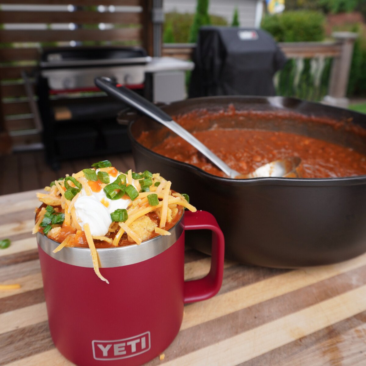 Over the top chili in a Yeti mug with all the toppings.