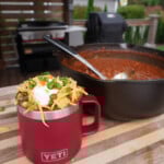 Over the top chili in a Yeti mug with all the toppings.