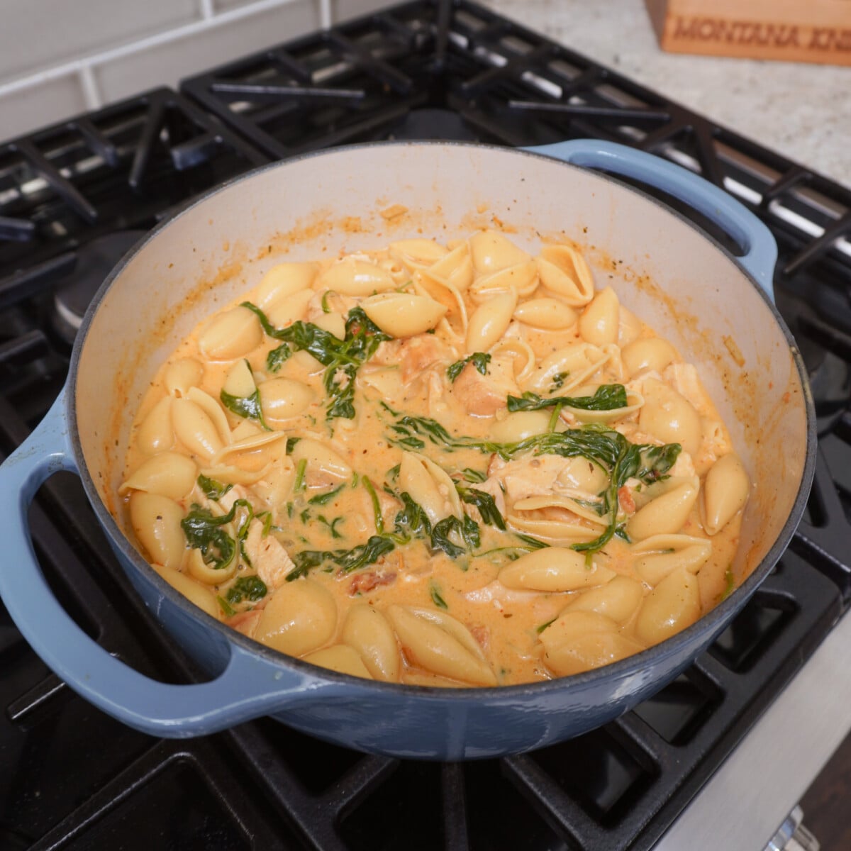 Cooked Easy Marry Me Chicken Soup in blue dutch oven over stove top.