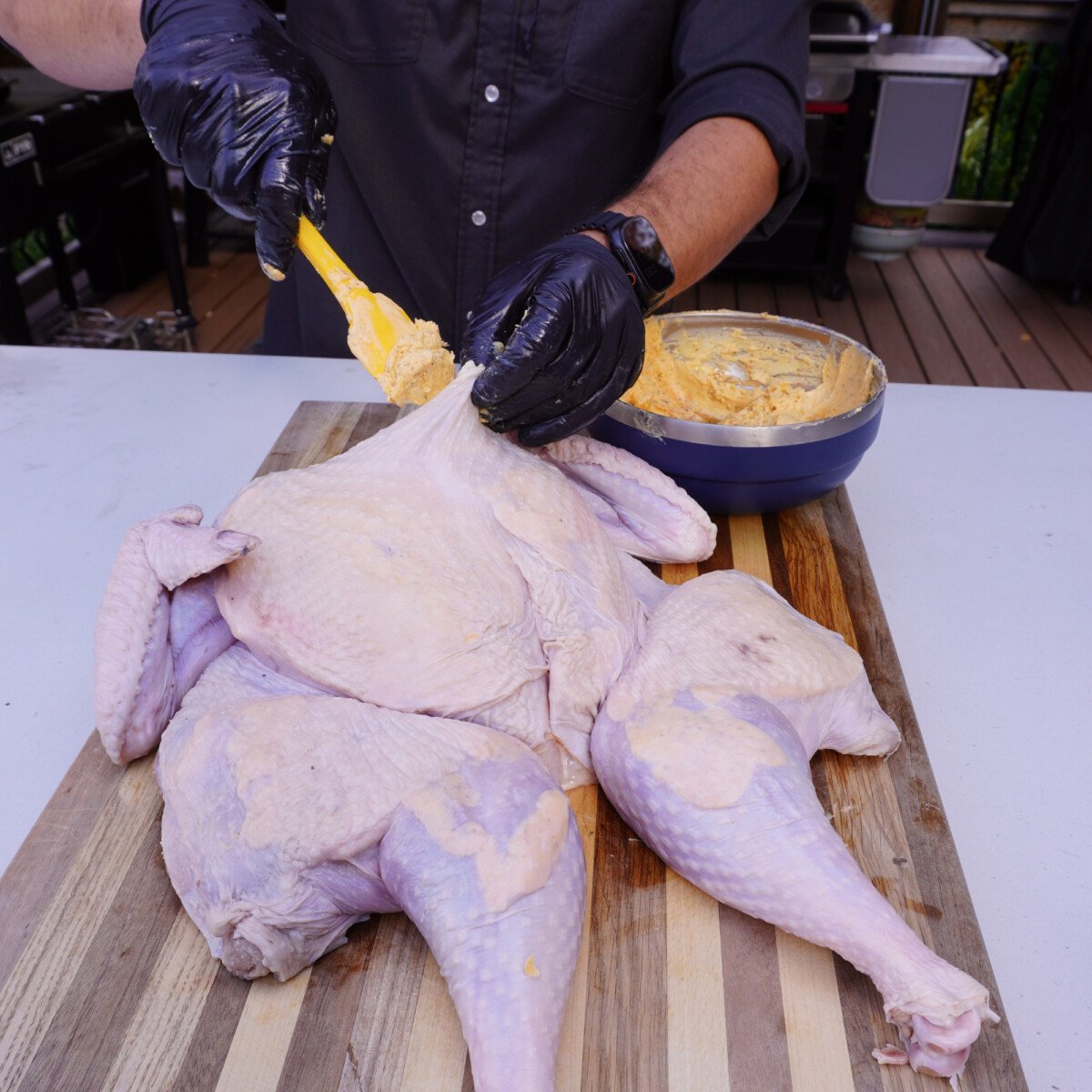 adding layers of butter under the turkey skin.