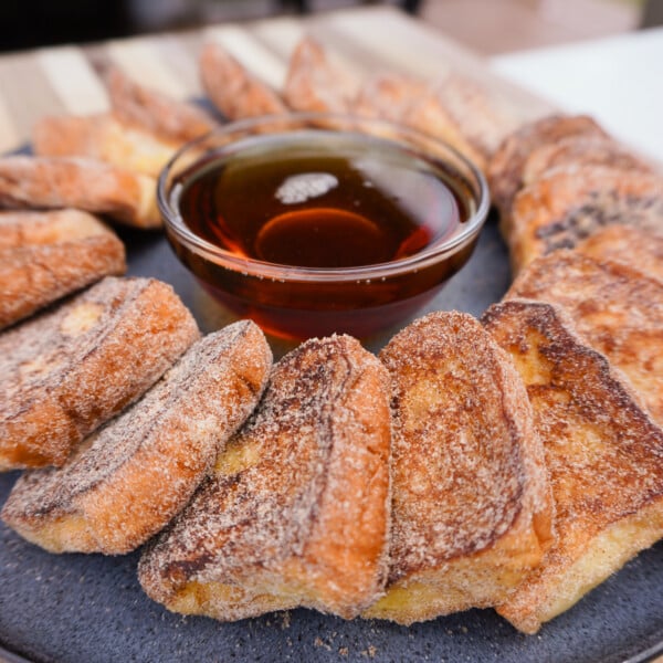 Easy grilled french toast plated with maple syrup in the middle.