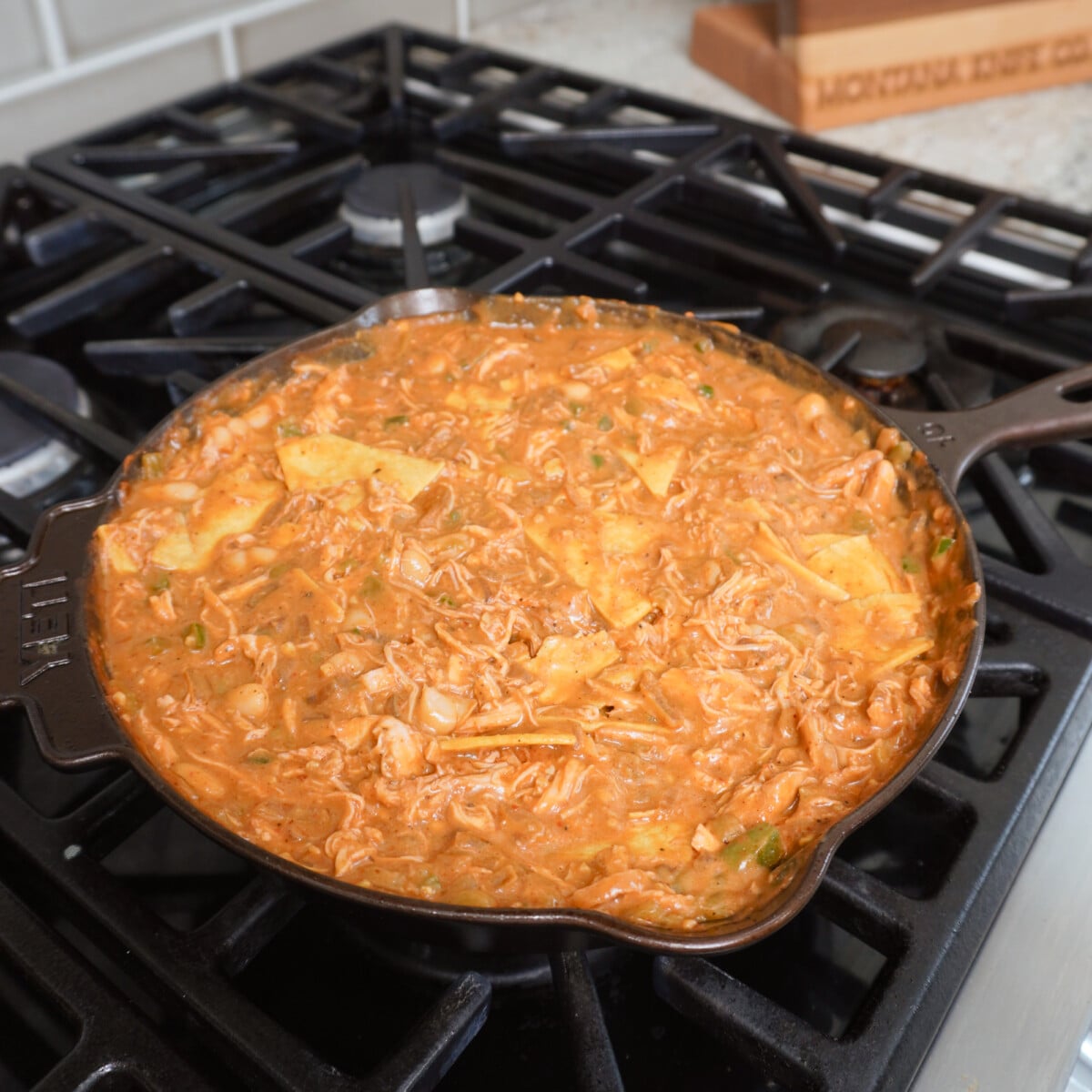 All ingredients incorporated into the Creamy Chicken Enchilada skillet before topping with shredded cheese.