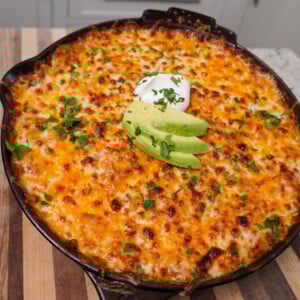 creamy chicken enchilada skillet on cutting board.
