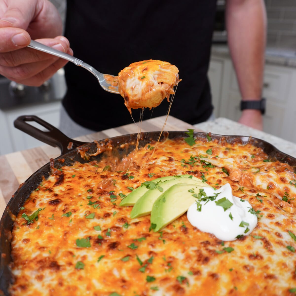loaded fork with the creamy chicken enchilada dish.