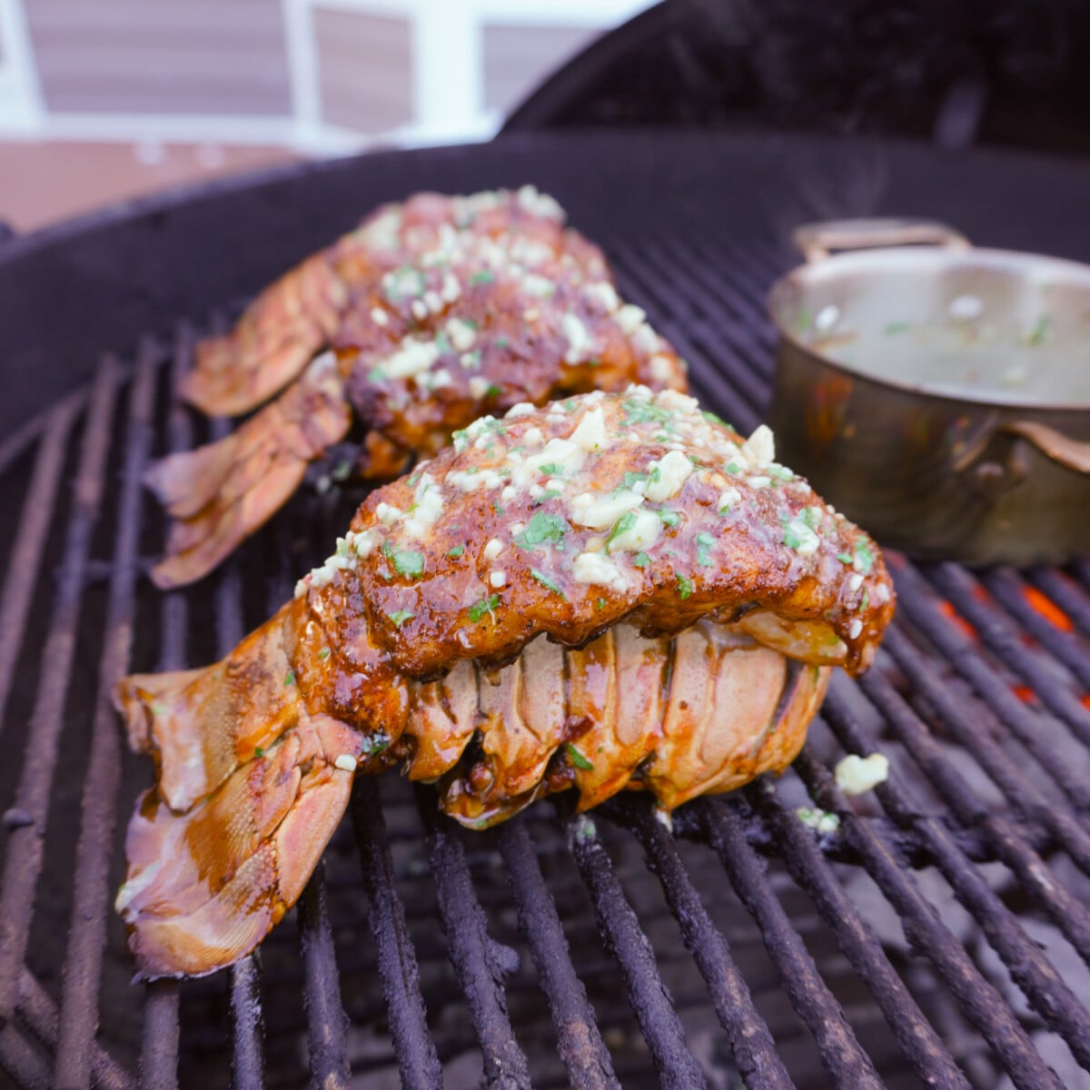 smoked cajun lobster tail on grill.