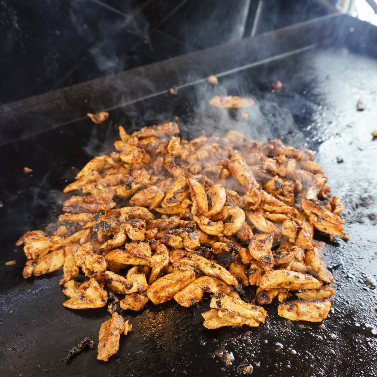 grilled chicken shawarma on a griddle.