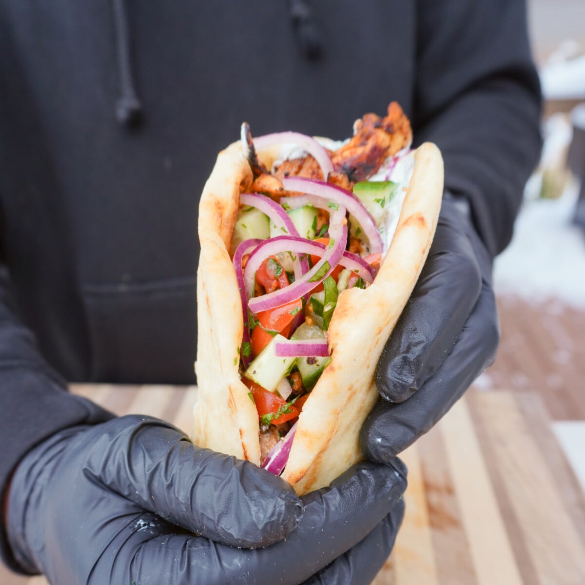 grilled chicken shawarma wrapped in a pita.