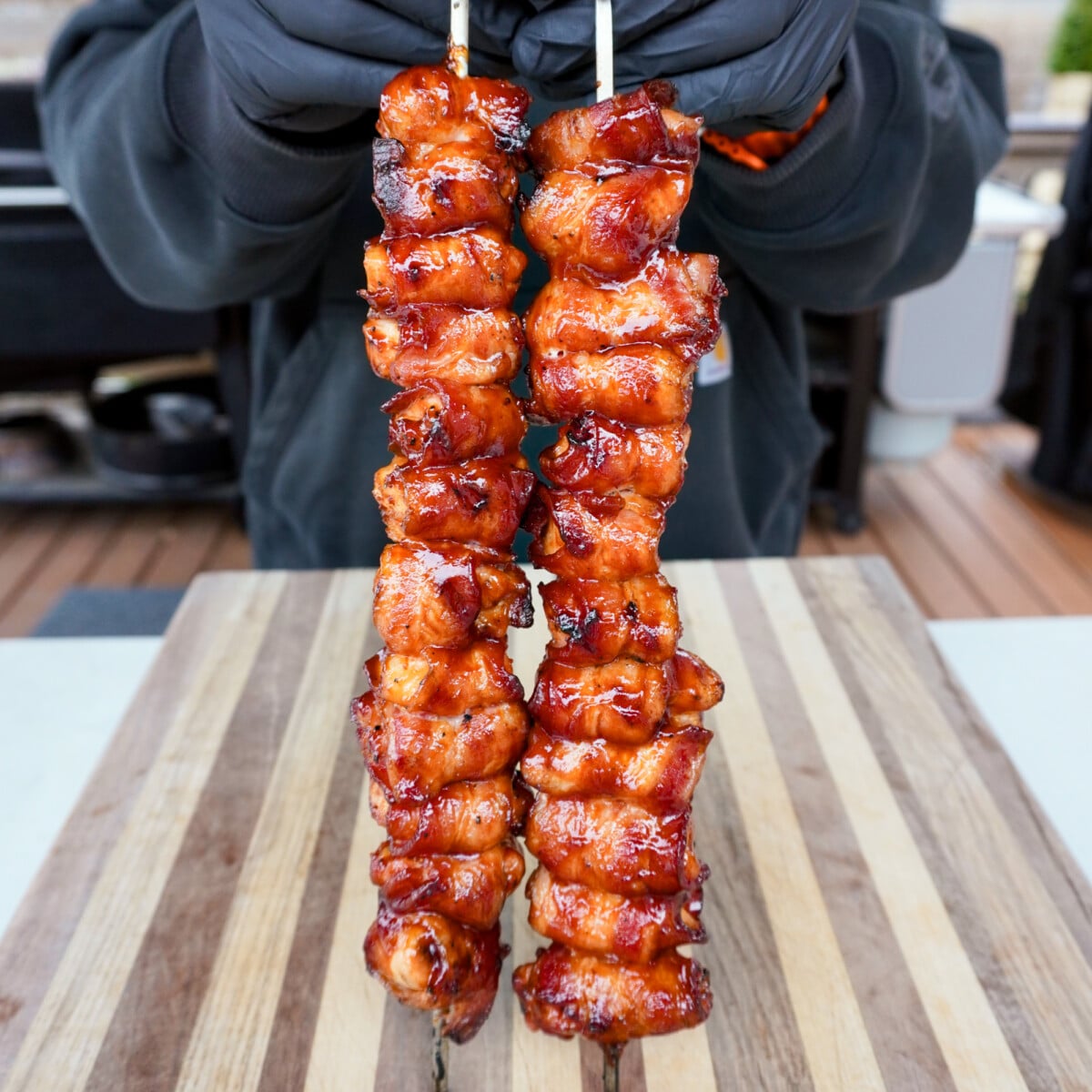 Bacon wrapped chicken skewers up right.