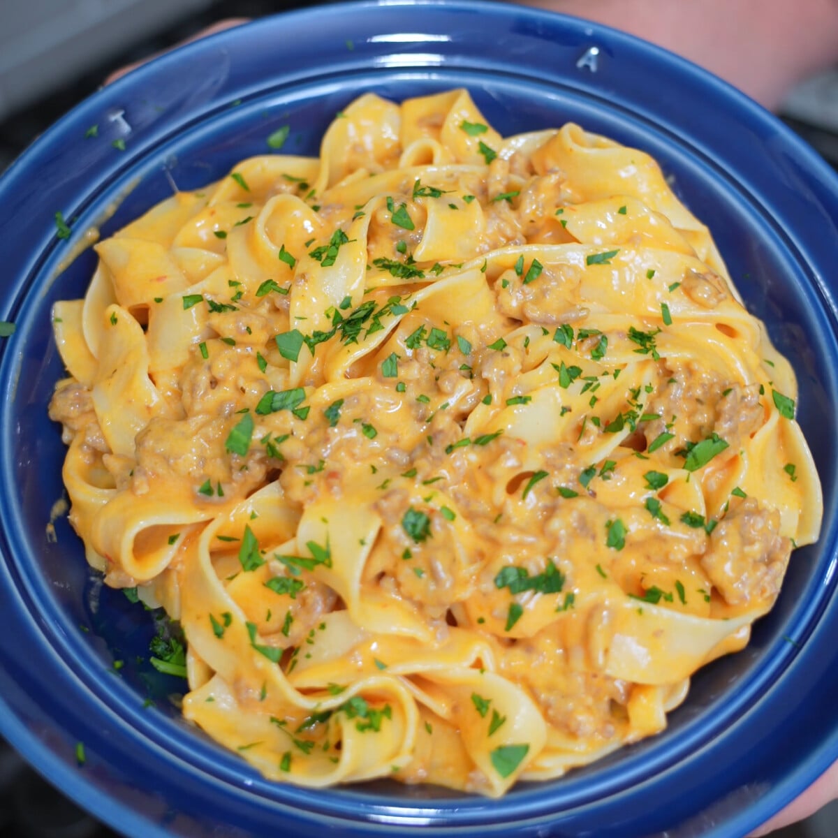 Creamy Italian Sausage Pasta in a blue dish.