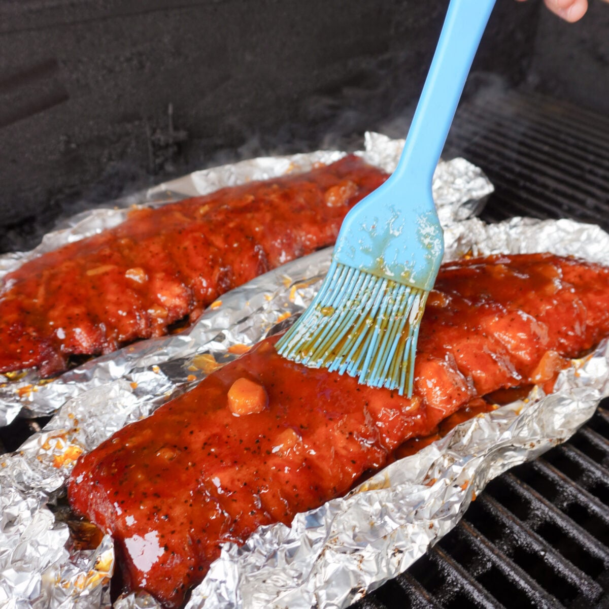 Saucing up the peach bourbon smoked ribs.