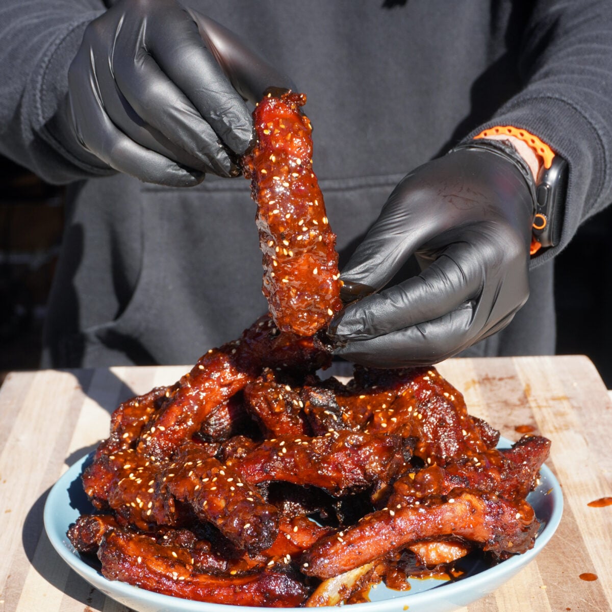 Chili Crunch Party Ribs presented by hand.