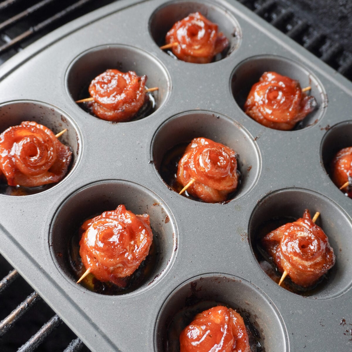 grilled bacon roses on grill in muffin pan.