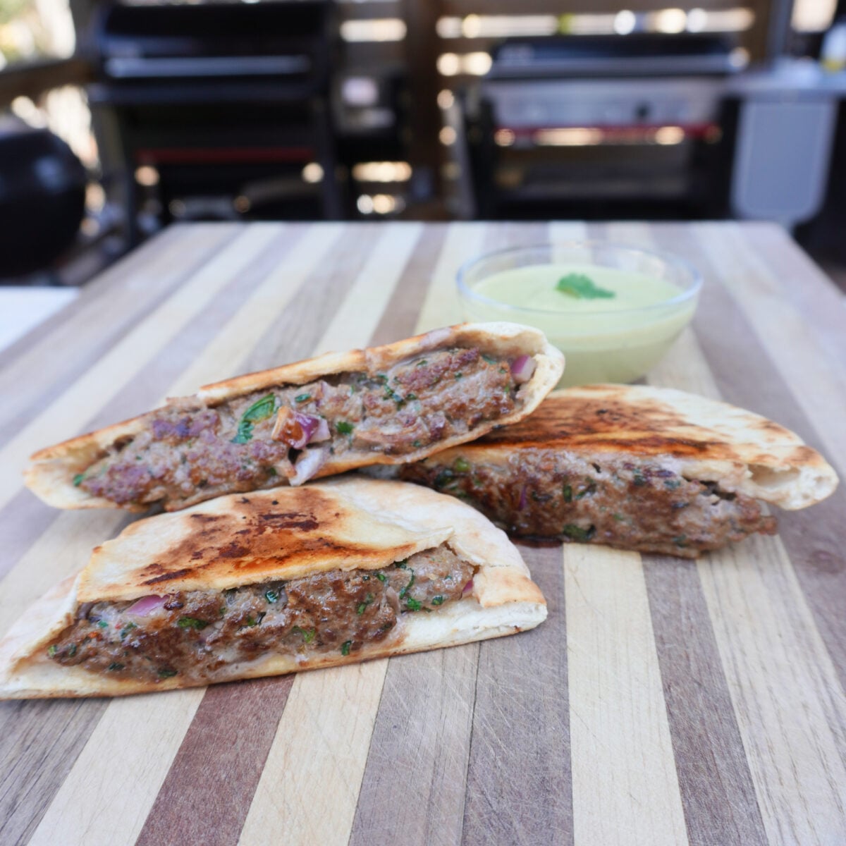 Grilled beef arayes on a cutting board.