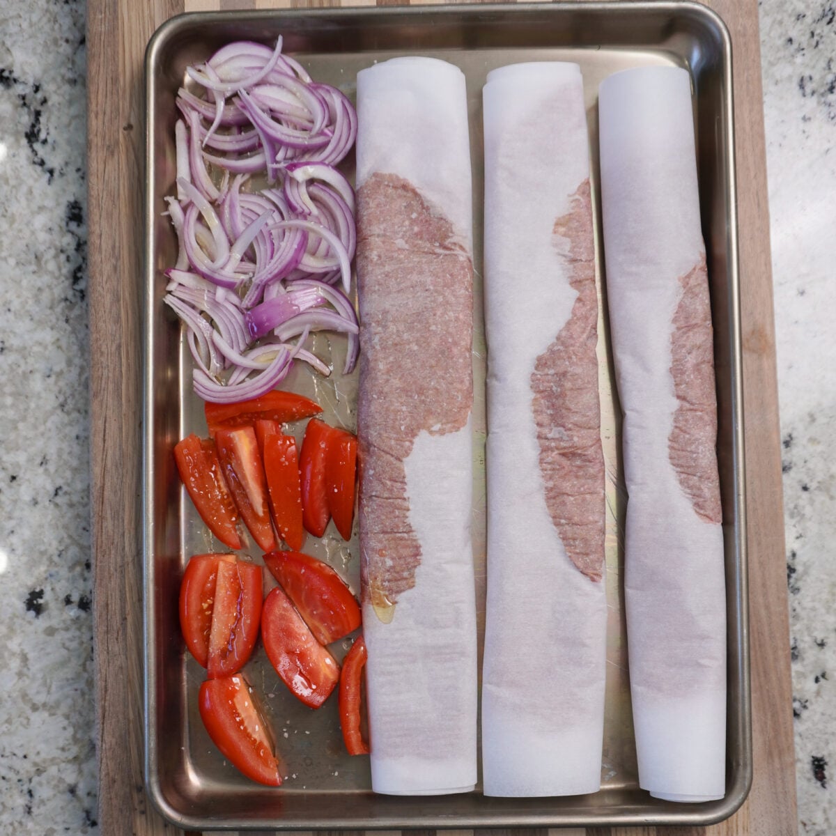 Sheet pan beef kebabs with all ingredients ready to be baked.