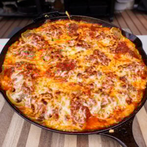 Smoked stuffed shells in a cast iron skillet.