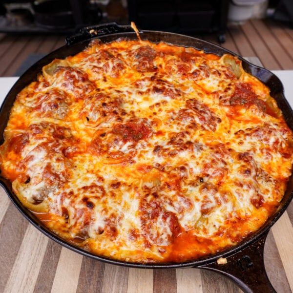 Smoked stuffed shells in a cast iron skillet.