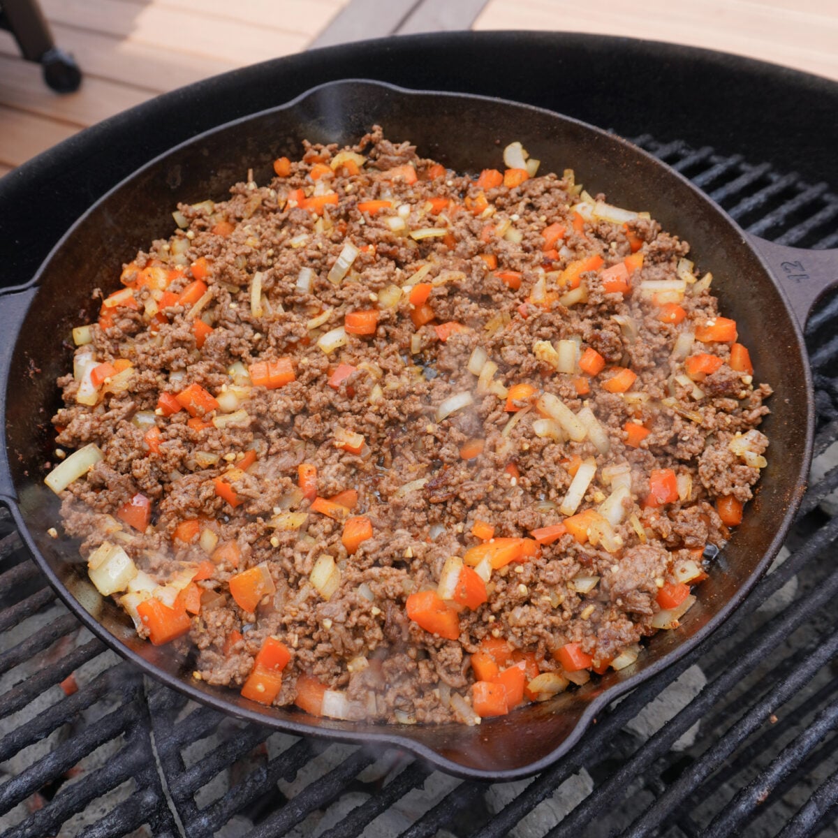 Ground beef and veggies in cast iron skillet.