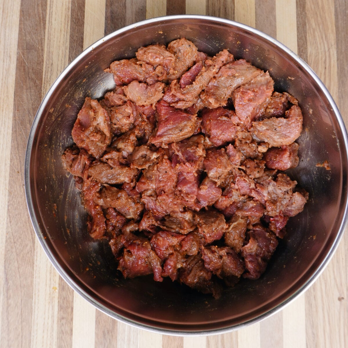 Seasoned steak bites in a bowl.