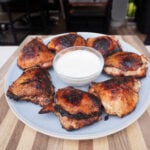 Grilled Pickle Brine Chicken Thighs on plate.