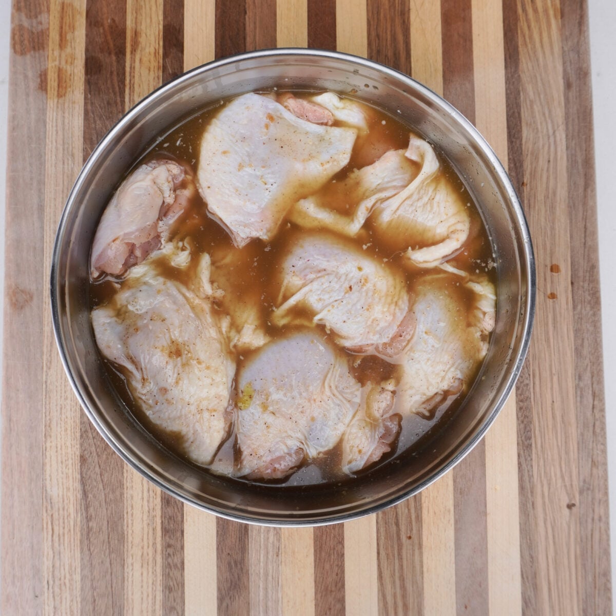 large bowl with brining chicken.