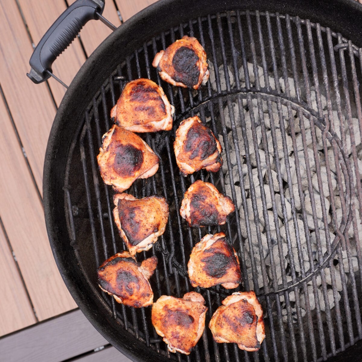 Grilled Pickle Brine Chicken Thighs on the indirect side of a charcoal grill.