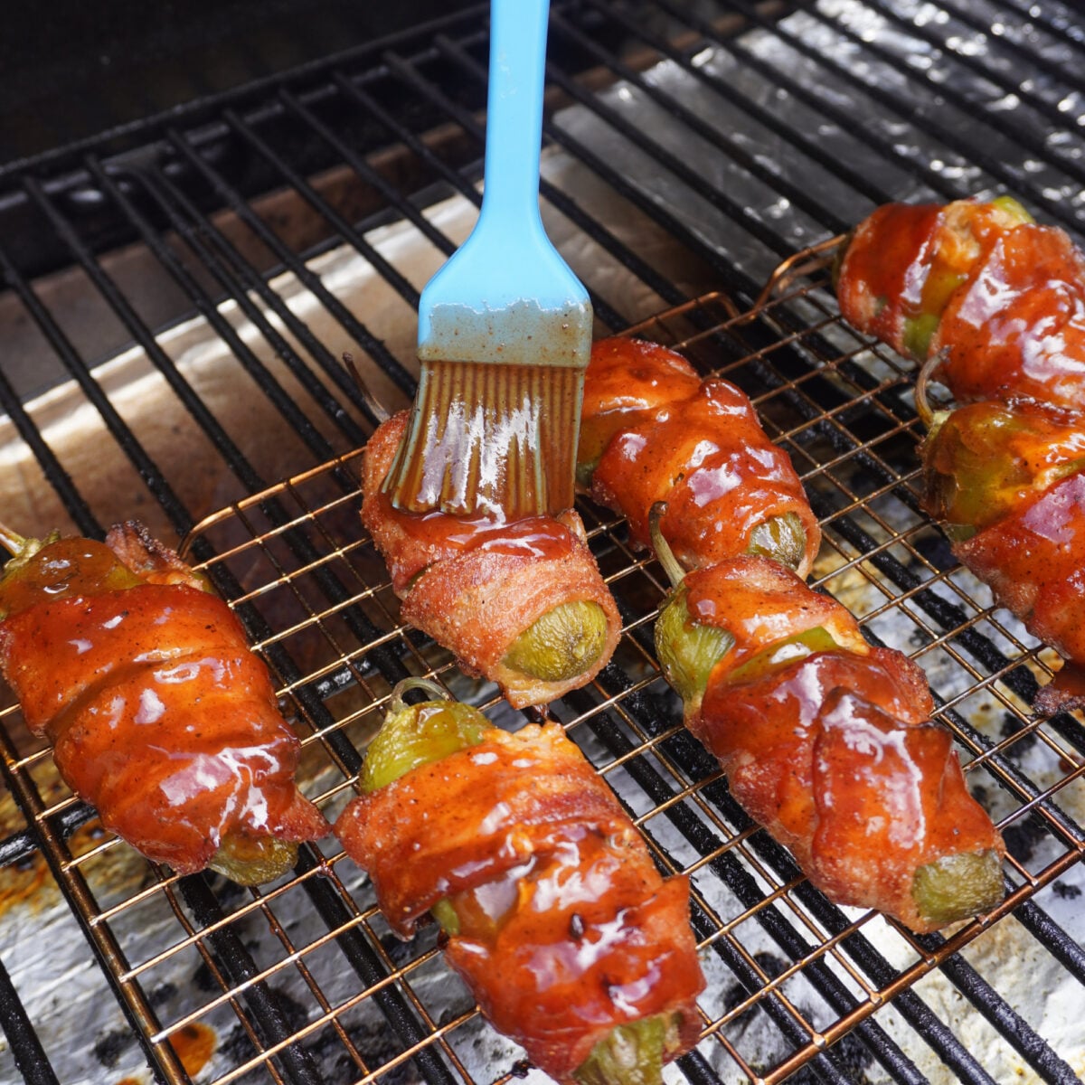BBQ sauce brushed pulled pork jalapeno poppers on the grill.