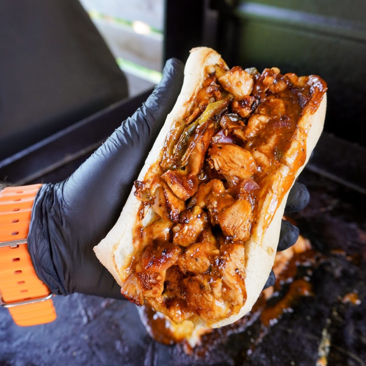 hand held chopped spicy chicken sandwich.