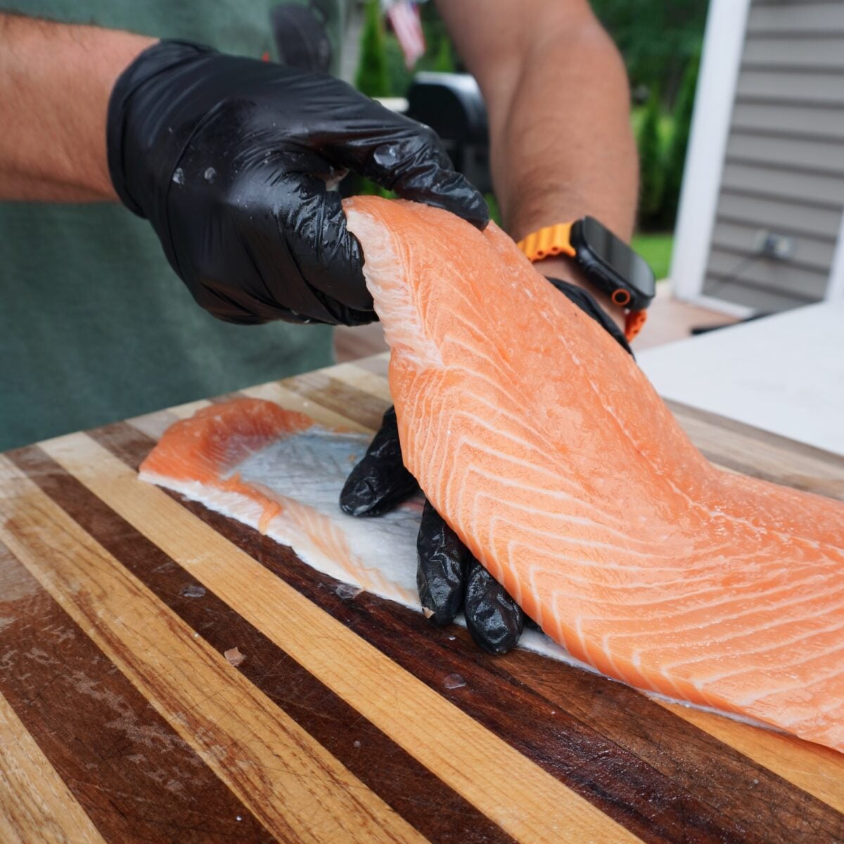 Showing how to separate salmon skin from meat.