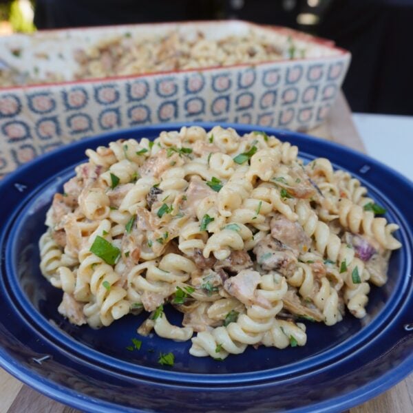 Caramelized Onion and Chicken Pasta dish on a blue plate.