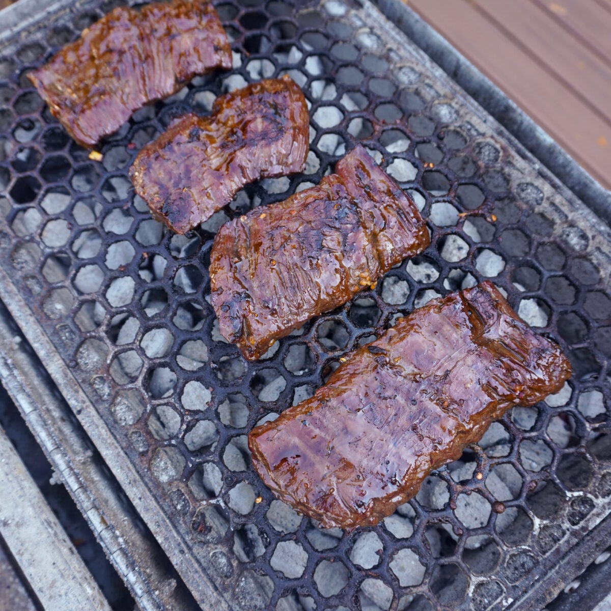 grilled skirt steak on charcoal grill.