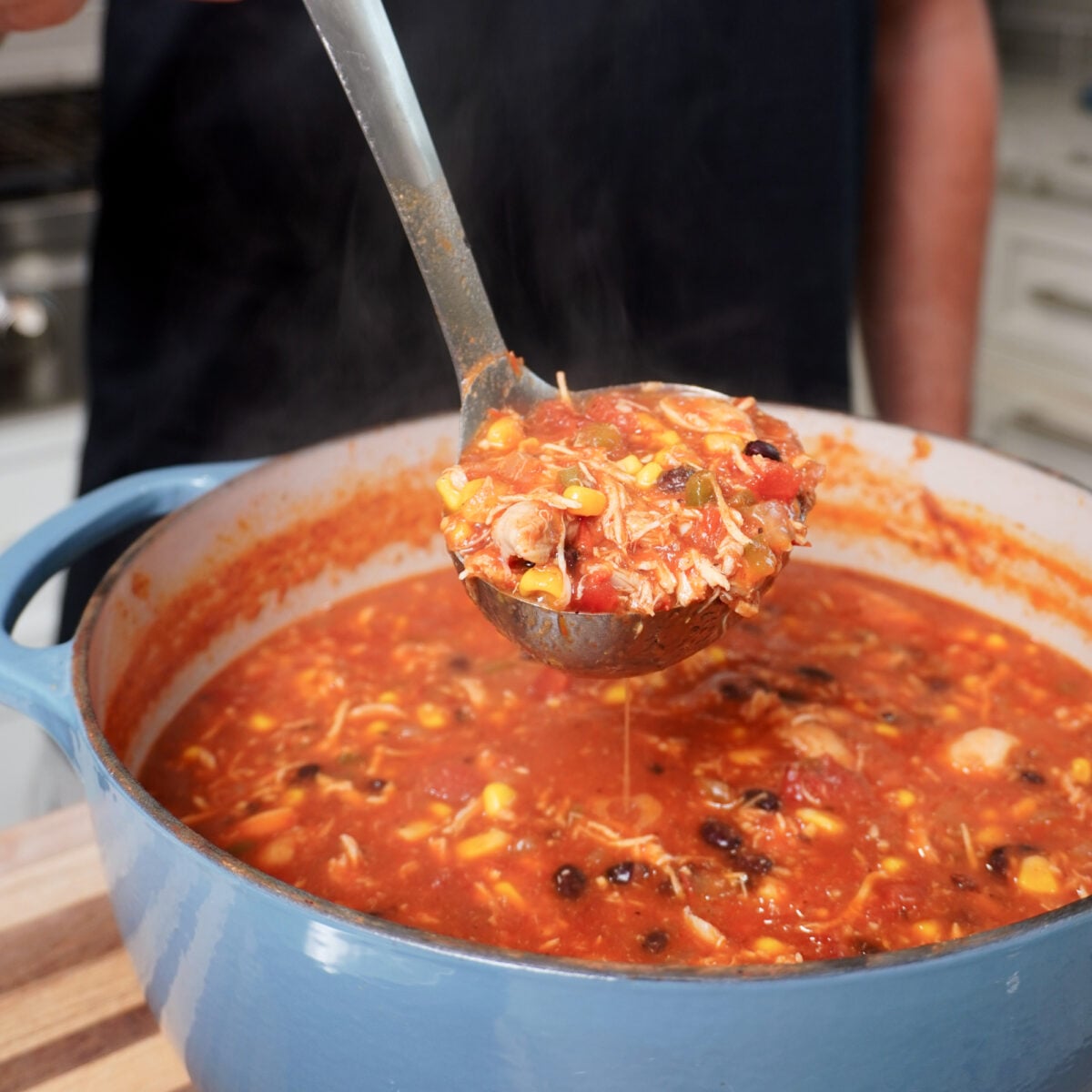 quick and easy chicken tortilla soup in laddle.